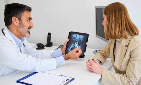 Doctor reviewing spinal image with patient